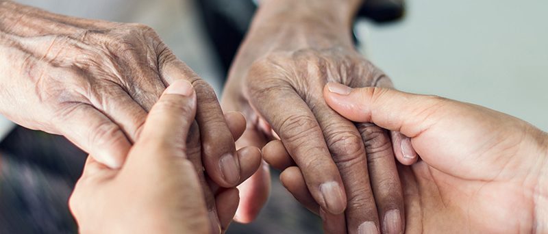 Close up hands of helping hands elderly home care. Mother and daughter. Mental health and elderly care concept