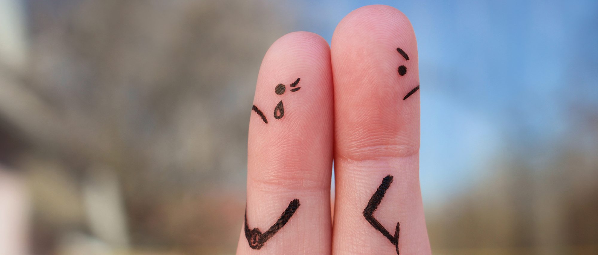 Fingers art of couple. Couple after an argument looking in different directions.